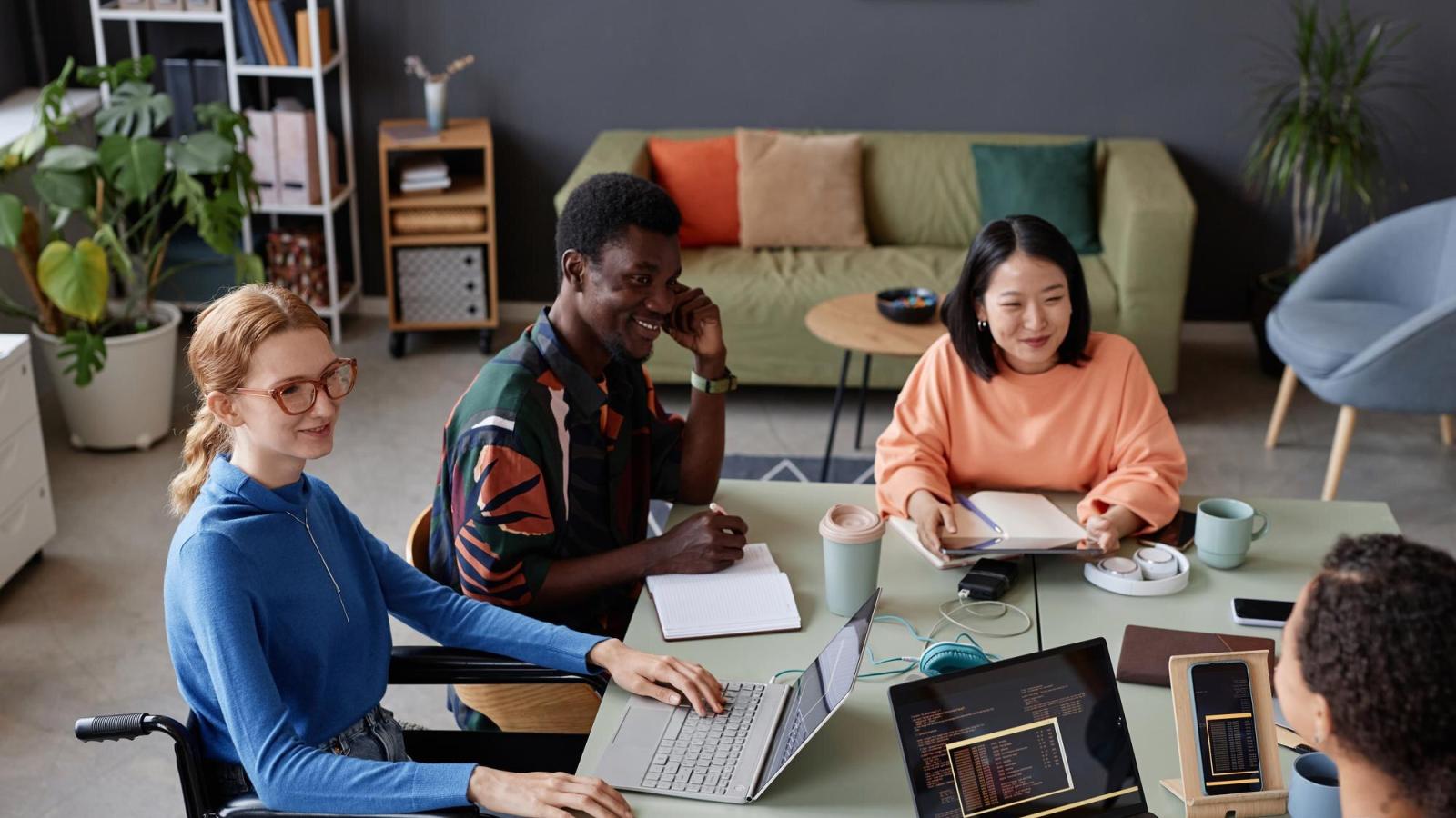 Young diverse team meeting at a table in the office